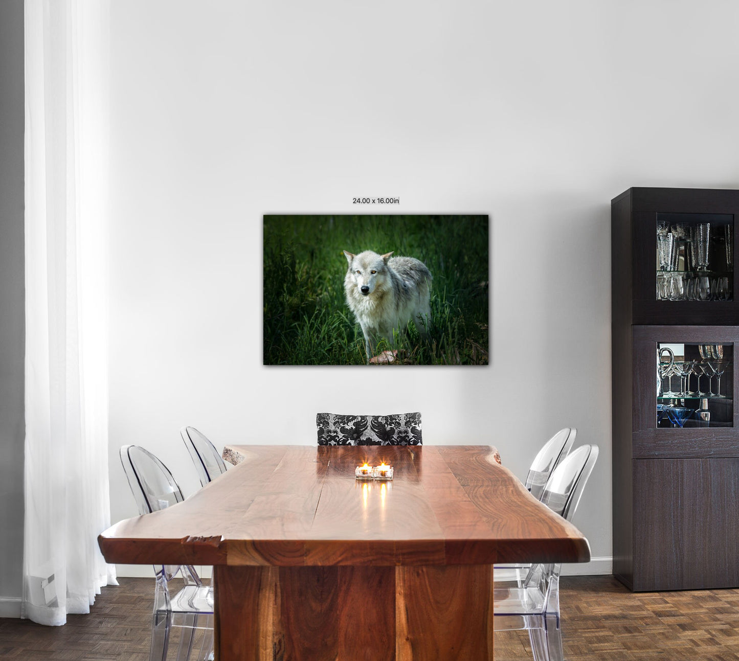 Photo of a canvas image of a gray wolf from Yellowstone National Park on a dining room wall with a cedar table.