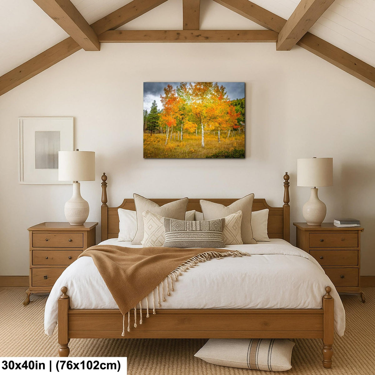 a cozy bedroom with a large bed, wooden furniture, and a painting of a forest scene hanging on the wall.