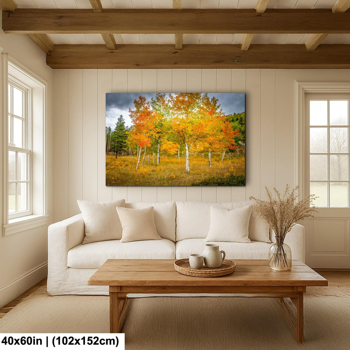 a cozy living room with a large, vibrant painting of a forest scene hanging on the wall above a white sofa.