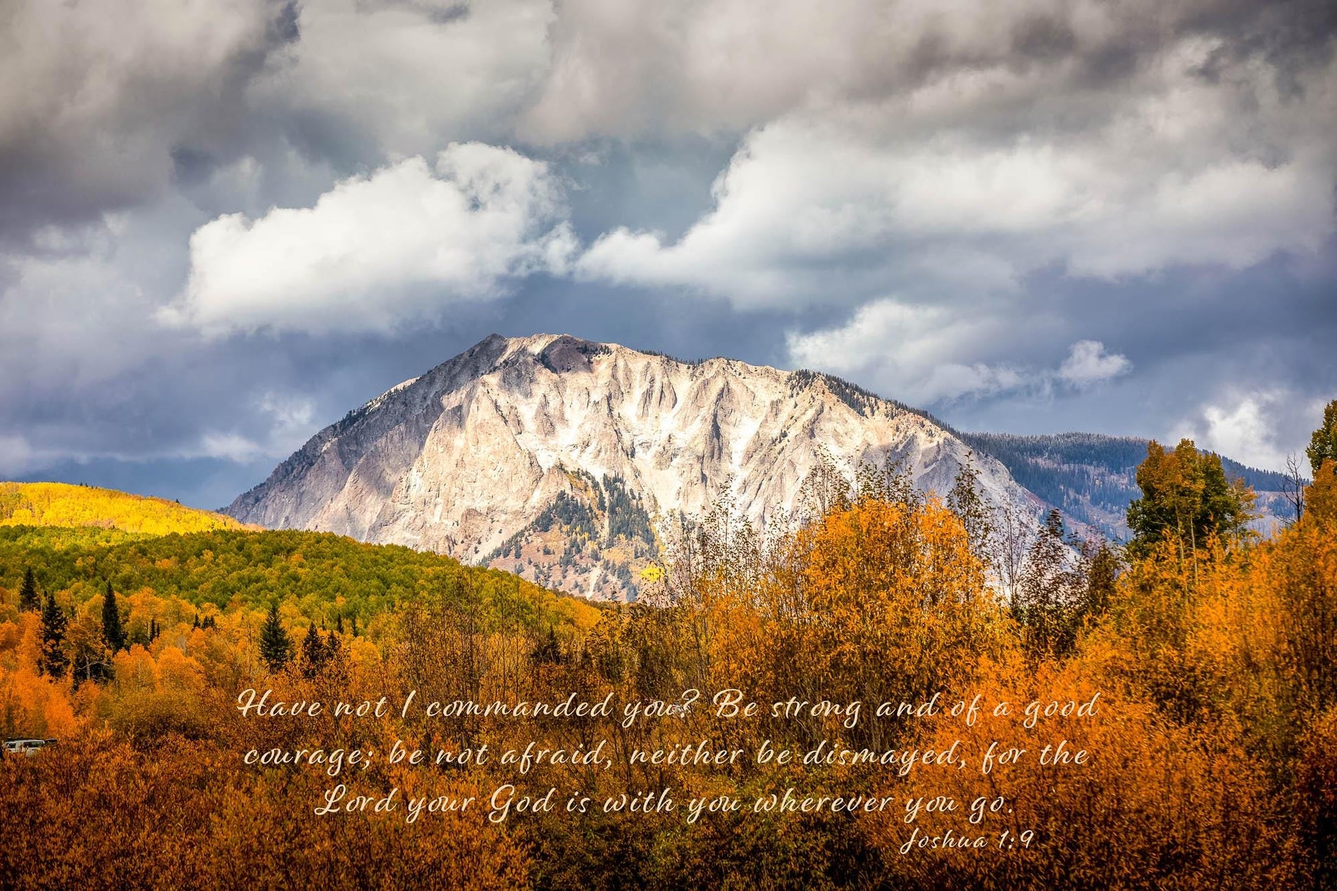 Beautiful snowy mountain peak rising above colorful fall aspens in Colorado. Scripture verse Joshua 1:9, &quot;Have I not commanded you? Be strong and of good courage; be not afraid, neither be dismayed, for the Lord your God is with you wherever you go.&quot;