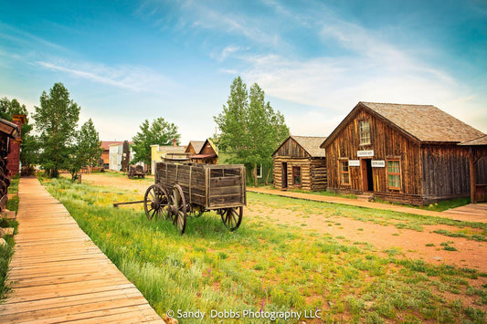 Old wagon in middle of road in old west ghost town.