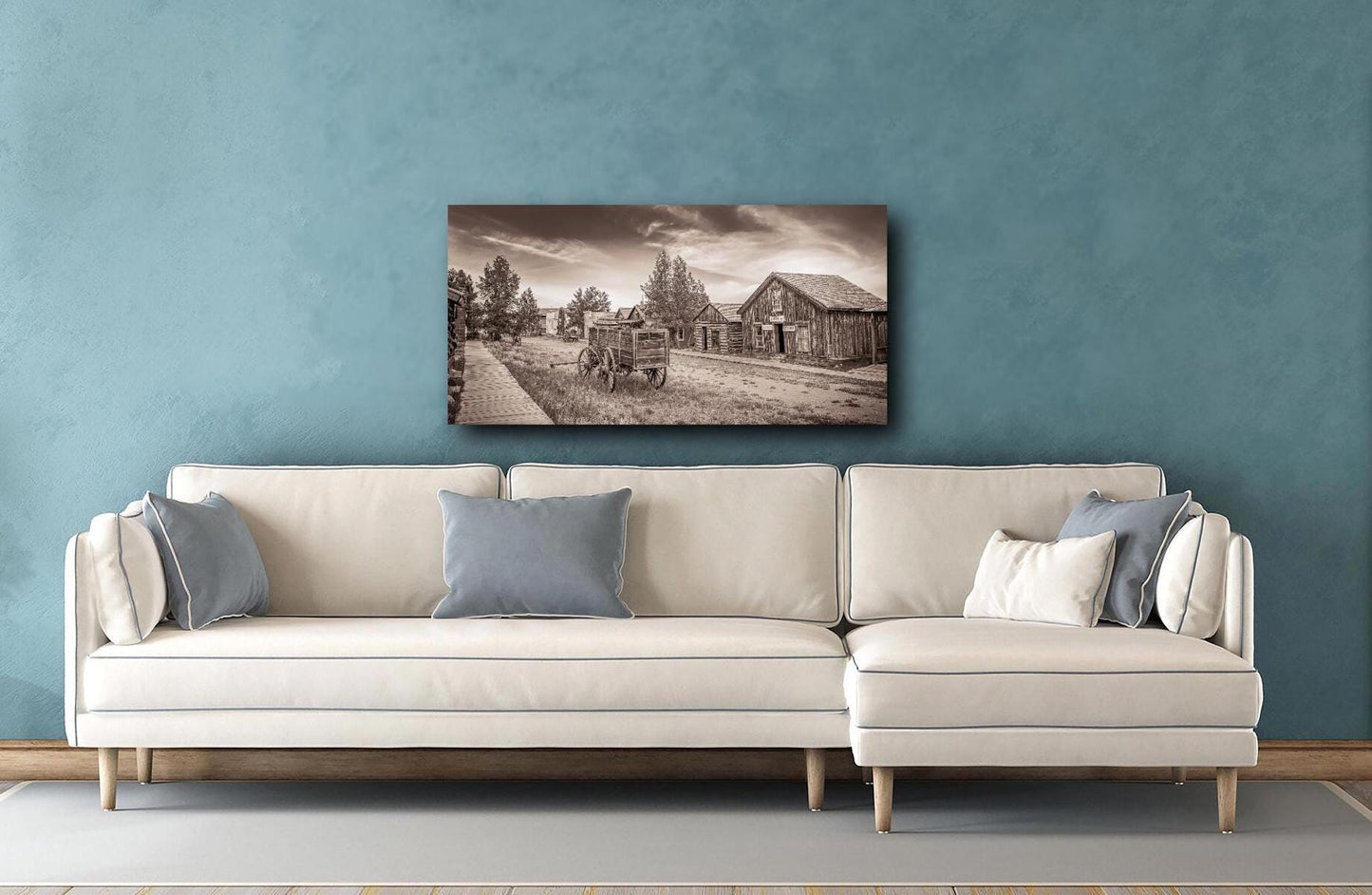 Old west town in Colorado print in sepia black and white. Mockup shown on canvas above couch