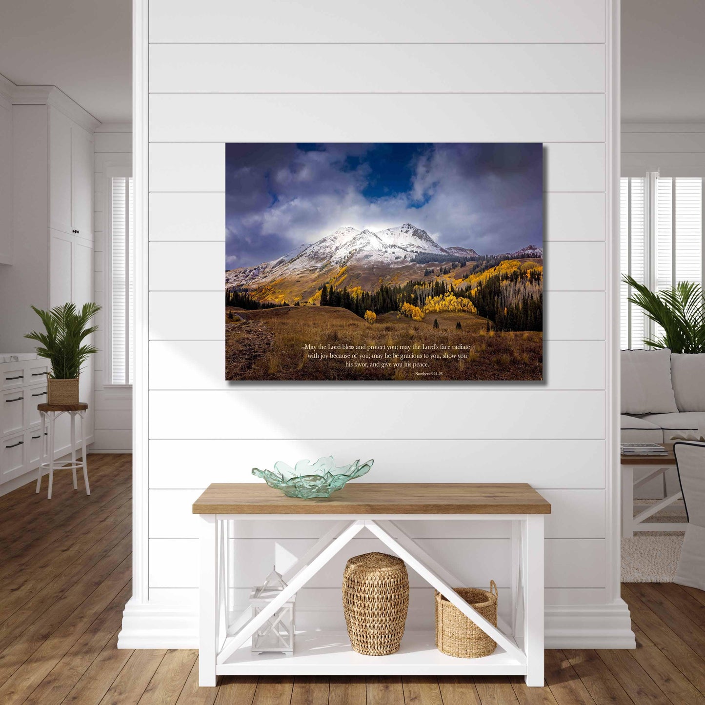 Numbers 6:24-26 verse on background of snowy mountain peak soaring over golden fall aspens in Colorado. Photo shows image printed on canvas. Shown on a white wall over a farmhouse style table