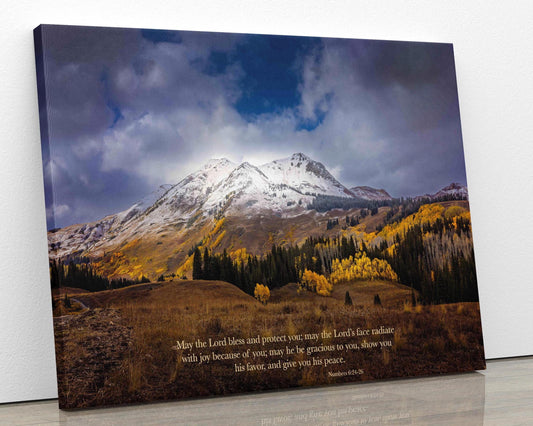 Numbers 6:24-26 verse on background of snowy mountain peak soaring over golden fall aspens in Colorado. Photo shows image printed on canvas.