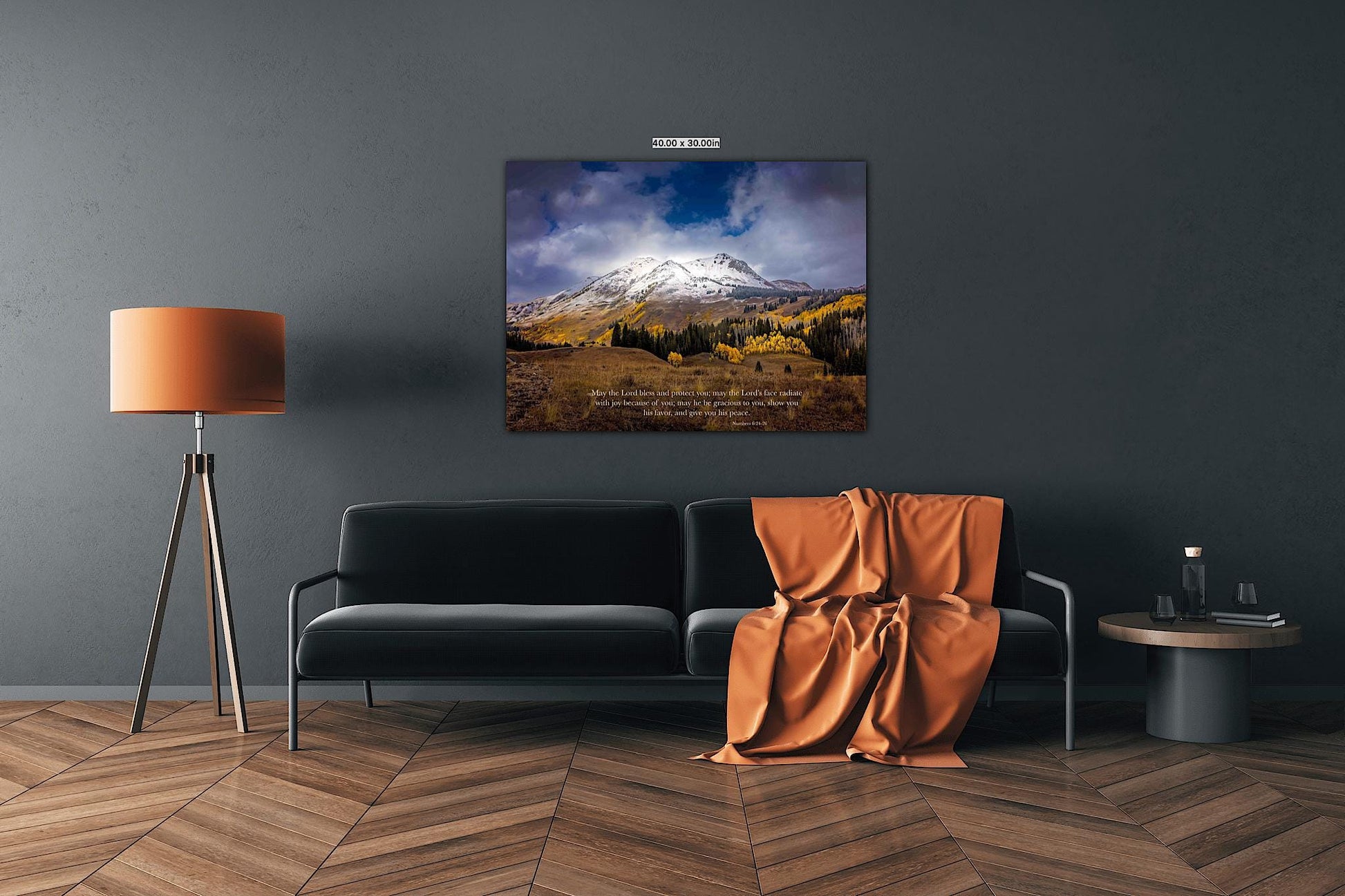 Numbers 6:24-26 verse on background of snowy mountain peak soaring over golden fall aspens in Colorado. Photo shows image printed on canvas. Shown over a dark couch with orange accents