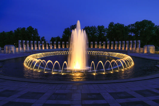 World War II Memorial at night in Washington D.C. - water is lighted.