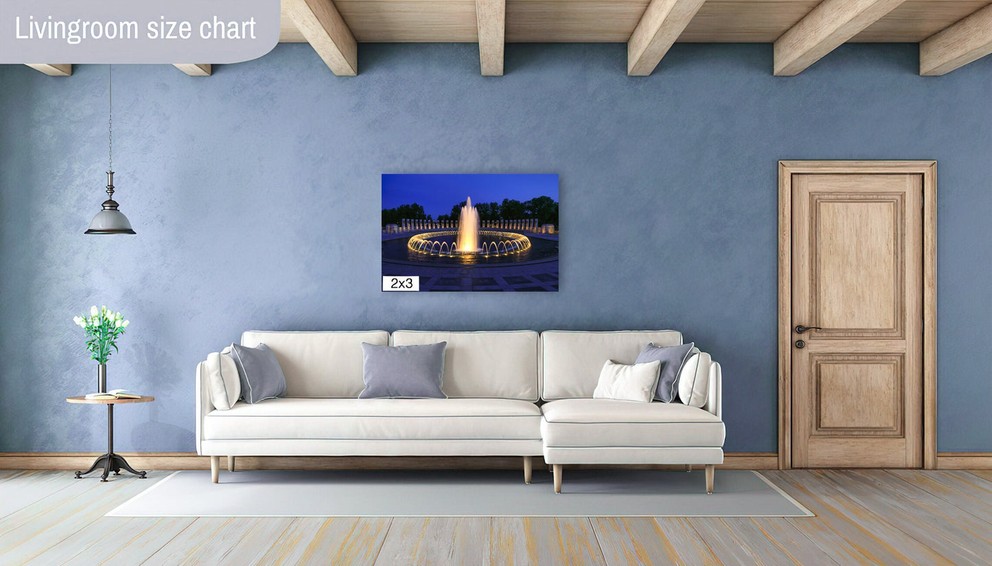 Photo of World War II Memorial in Washington D.C. at night featured on a blue wall with cream colored sofa.