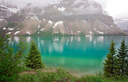 Bow Lake near Banff National Park. Beautiful mountain lake with gorgeous turquoise water and mountains with snow.