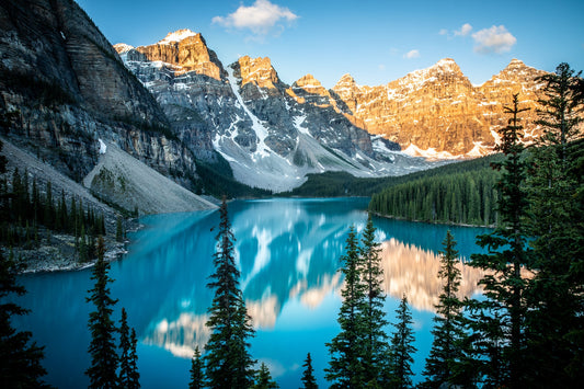 Sunrise hitting the peaks around Moraine Lake in Banff, Canada. Beautiful turquoise
water and reflection. Canadian Rockies canvas print.
