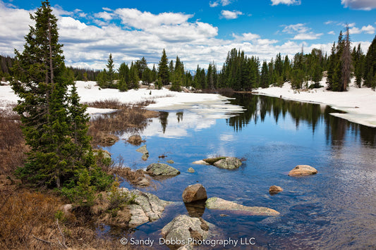 Beautiful blue skies reflecting in the war with  snow around, along the Beartooth Highway in Montana. Available as a canvas or fine paper print.