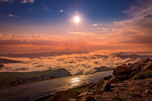 Beautiful colorful sunrise above the clouds at the summit of Mount Evans, Colorado. Offered by the original photographer. Available in prints and canvases.